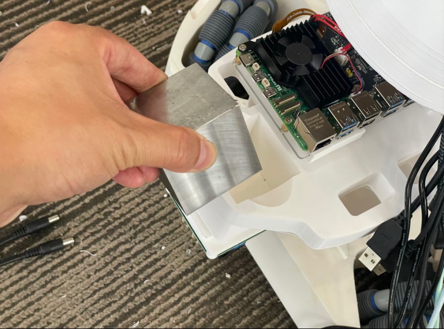 Raspberry Pi, buck converter, batteries, and counterweight in rear support